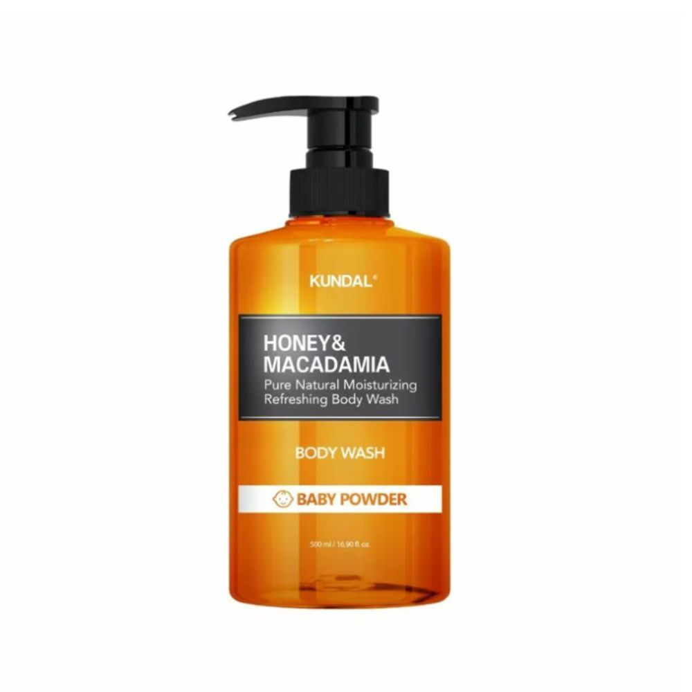 Orangefarbene Pumpflasche mit KUNDAL Honey & Macadamia Body Wash, Baby Powder Duft.