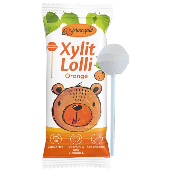 Verpackung mit Xylit Lolli Orange. Abbildung eines Bären. Aufschrift: Zuckerfrei, Vitamin D, Magnesium und Vitamin K.