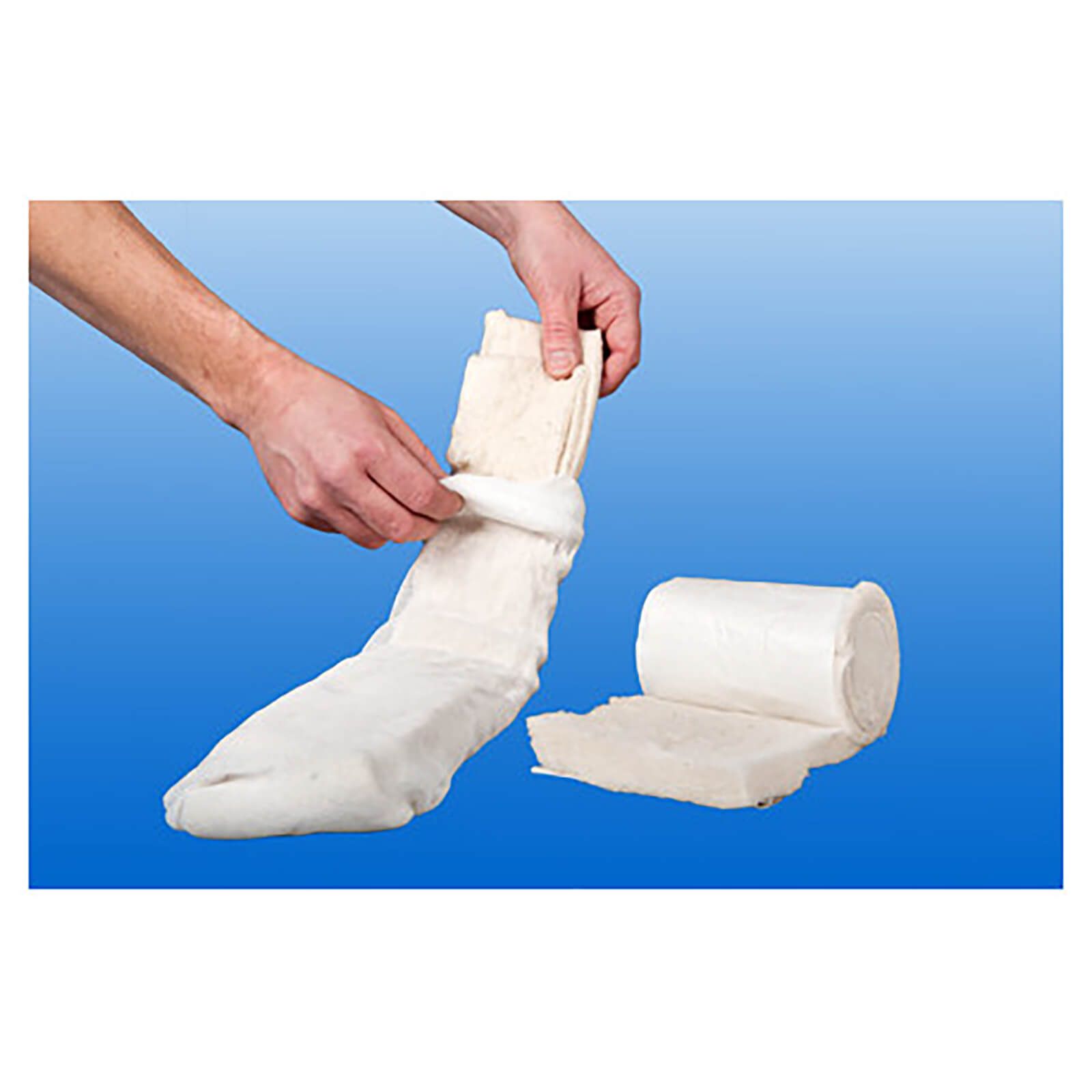 Hände halten Polsterwatte. Eine Rolle und ein Stück Watte sind sichtbar. Hintergrund blau.