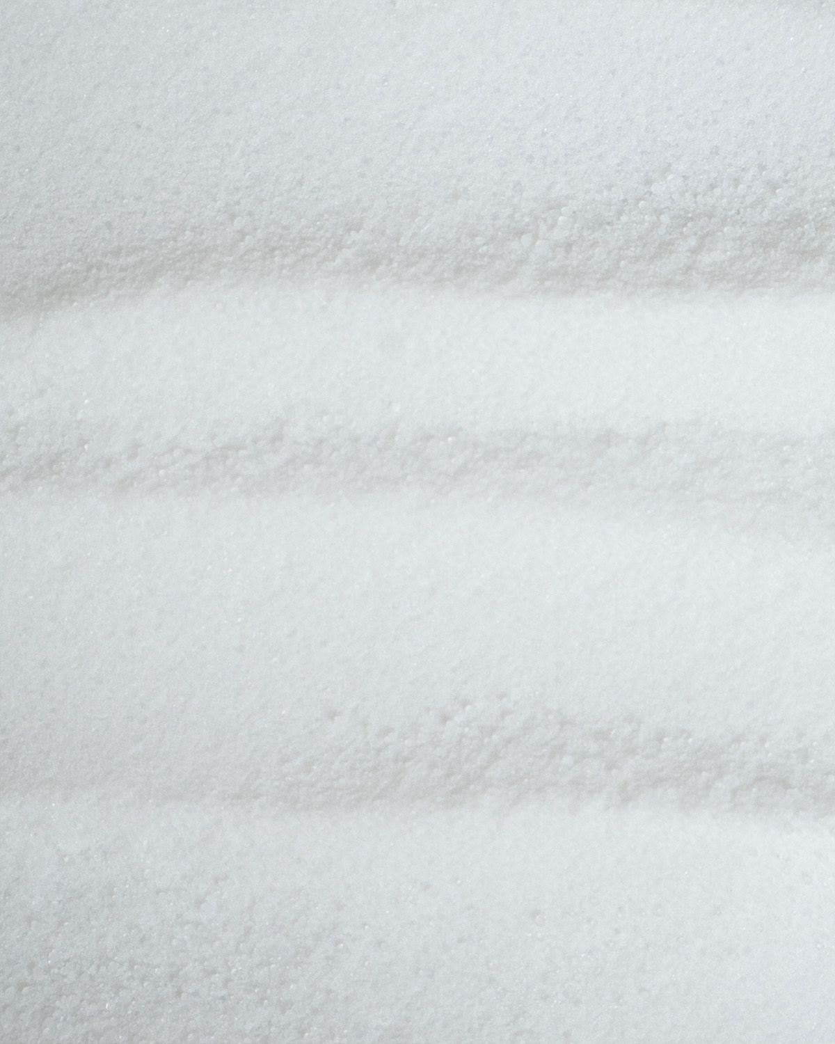 Nahaufnahme von weißem Pulver mit horizontalen Streifen.