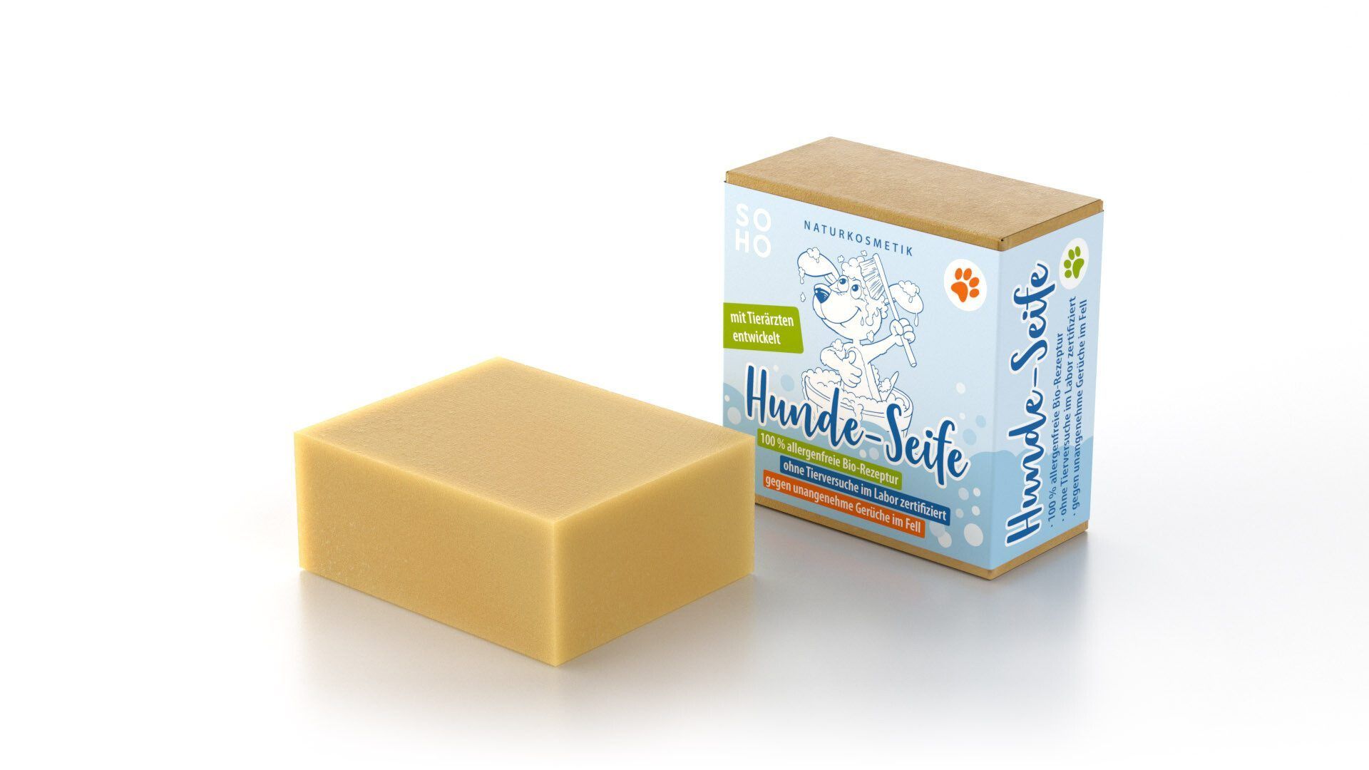 Rechteckige Seife neben Verpackung. Verpackung mit Produktname und Illustration eines Hundes. Seife in hellbrauner Farbe.