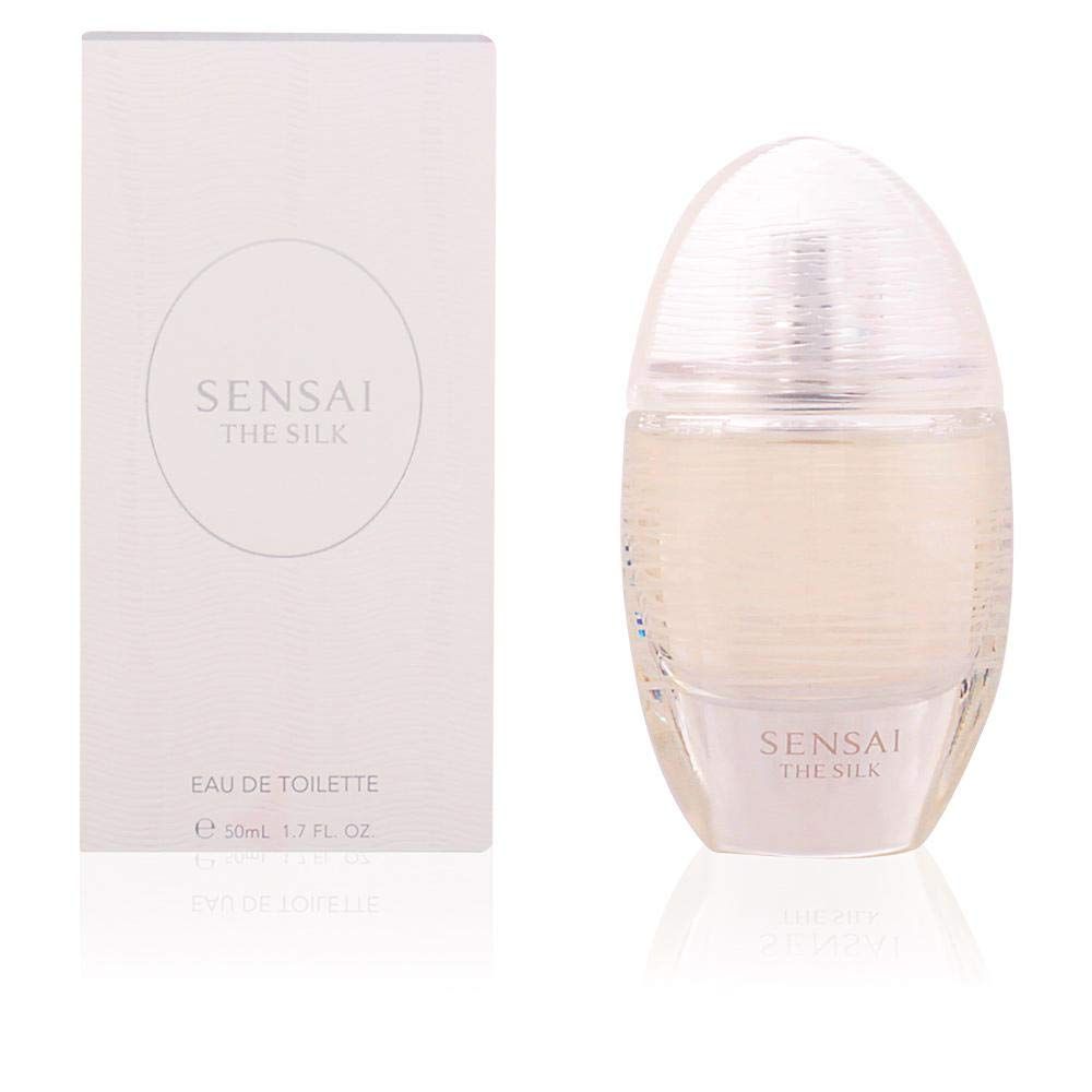 Weiße Verpackung und ovale Flasche. Auf der Verpackung steht "SENSAI THE SILK" und "EAU DE TOILETTE". Die Flasche ist durchsichtig.
