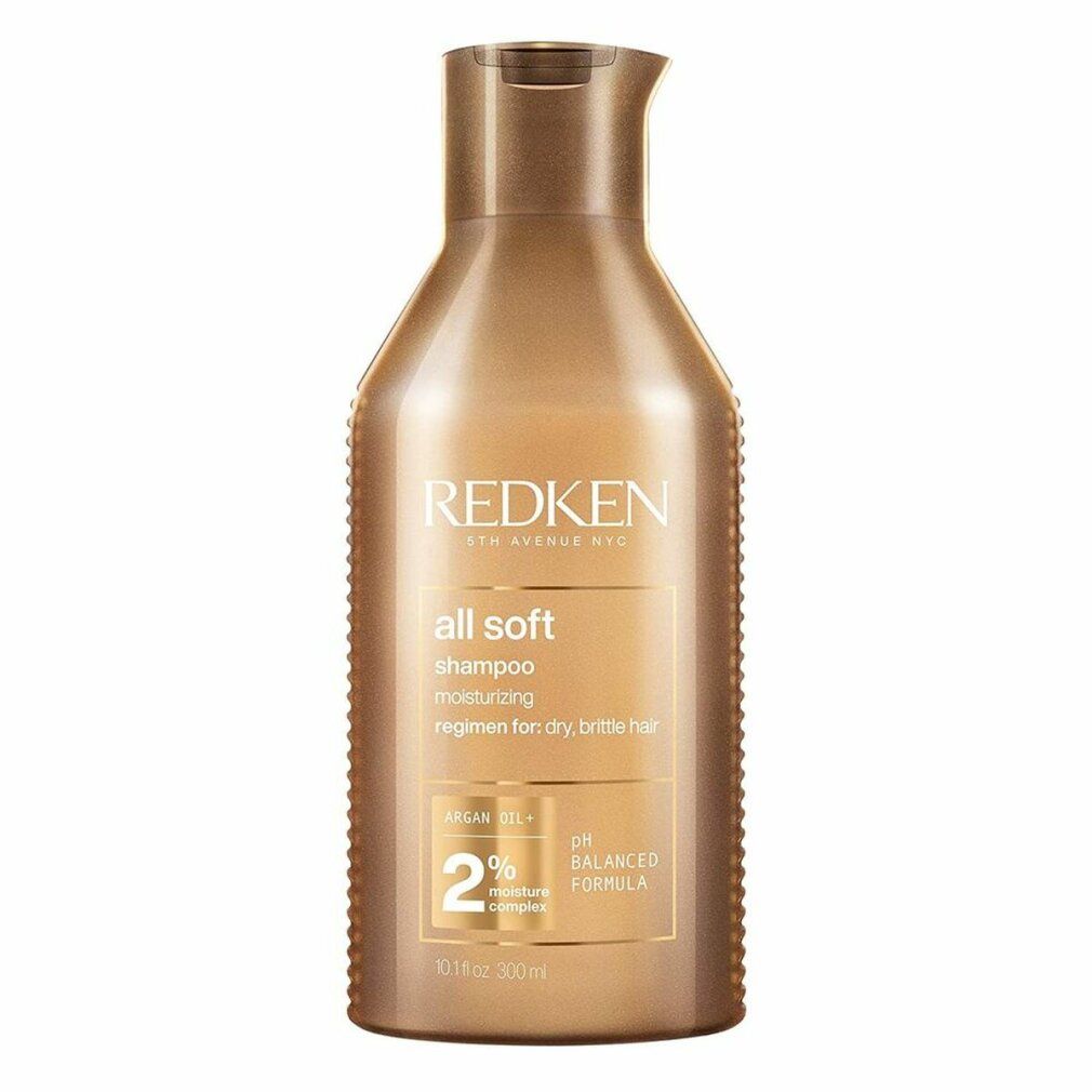 Goldfarbene Shampoo-Flasche mit "Redken" und "all soft". Enthält Arganöl und 2% Feuchtigkeitskomplex. pH-ausgeglichene Formel.