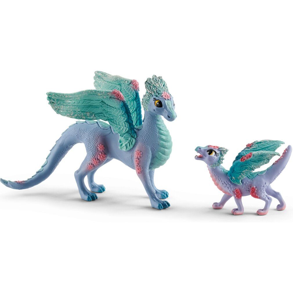 Zwei lilafarbene Drachenfiguren mit blauen Flügeln und roten Akzenten. Ein großer und ein kleiner Drache.