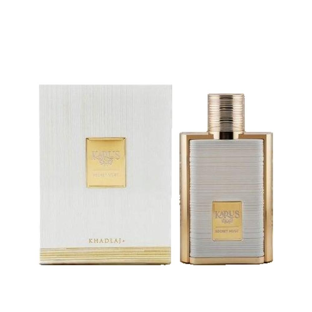 Parfümflakon und Verpackung. Rechteckiger Flakon mit goldfarbenen Akzenten. Weiße Verpackung mit goldenem Logo.