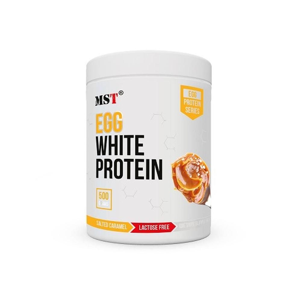 Weißer Behälter mit gelben und roten Akzenten. Aufschrift: MST EGG WHITE PROTEIN, 500, Laktosefrei. Abbildung: Karamell.
