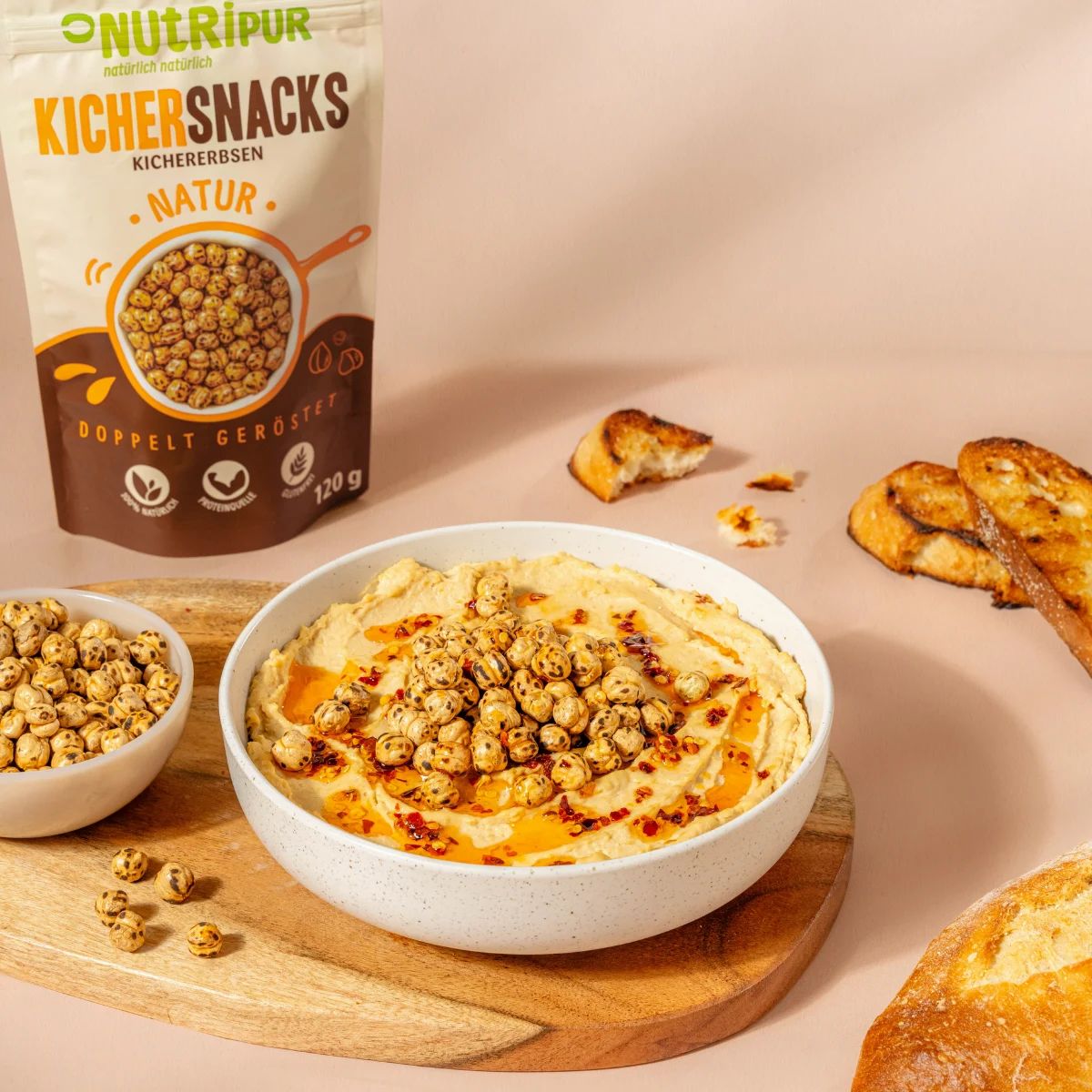Hummus mit doppelt gerösteten Kichererbsen und Brot. Kichererbsen auf Hummus. Brot mit Hummus und Kichererbsen.