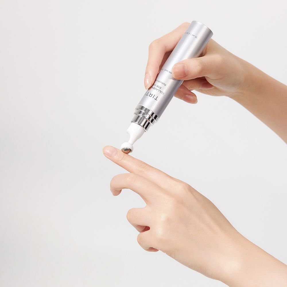 Hände halten silberne Tube mit Applikator. Applikator berührt Finger. Text: TIR TIR Collagen Lifting Eye Cream.