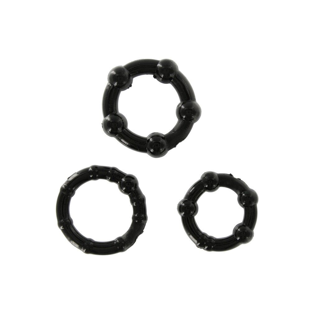 Drei schwarze Penisringe. Oben ein Ring mit Kugeln, darunter zwei Ringe mit Noppen. Alle Ringe sind rund.