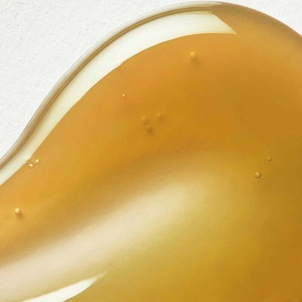 Gelartige Substanz in Goldgelb. Auf hellem Untergrund. Textur mit kleinen Bläschen.