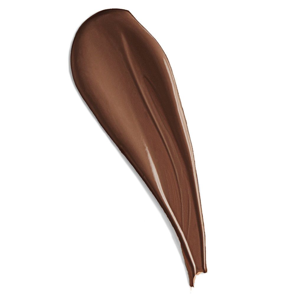 Dunkelbrauner Concealer-Abstrich auf weißem Hintergrund. Textur sichtbar.