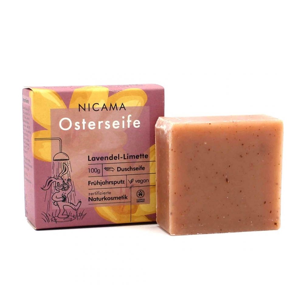 NICAMA Osterseife, rechteckige Seife neben Verpackung. Verpackung mit Produktnamen, Inhaltsangabe und Illustration. Zertifizierte Naturkosmetik.