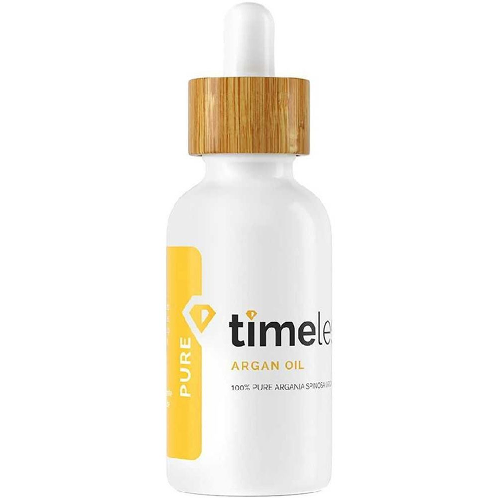 Weiße Flasche mit Holzdeckel und Pipette. Gelbes Etikett mit "timeless" und "Argan Oil" Schriftzug.