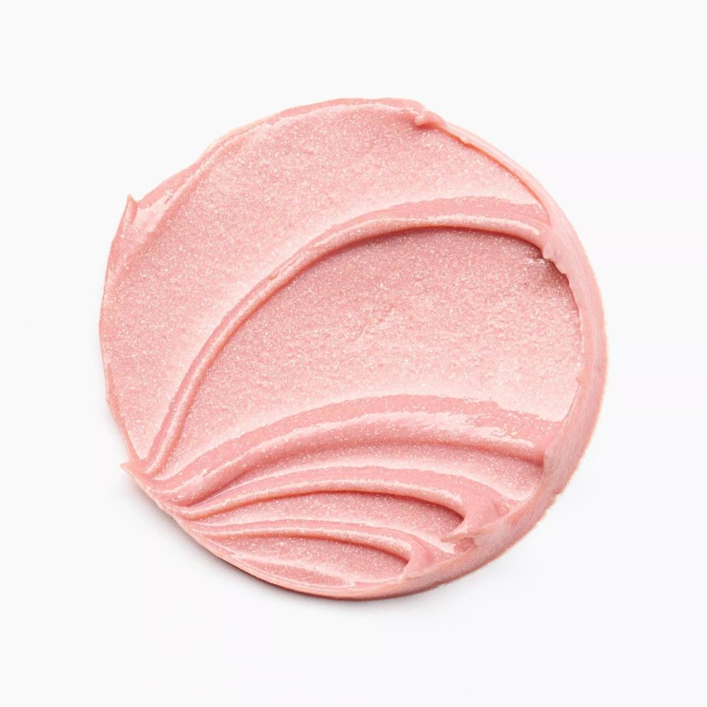 Rosa Lippenbalsam-Abstrich auf weißem Hintergrund. Die Textur ist cremig und glänzend.