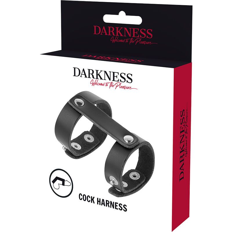 Verpackung mit Produkt. Schwarzer Lederring mit zwei Ringen. Auf der Verpackung steht "DARKNESS" und "Cock Harness".