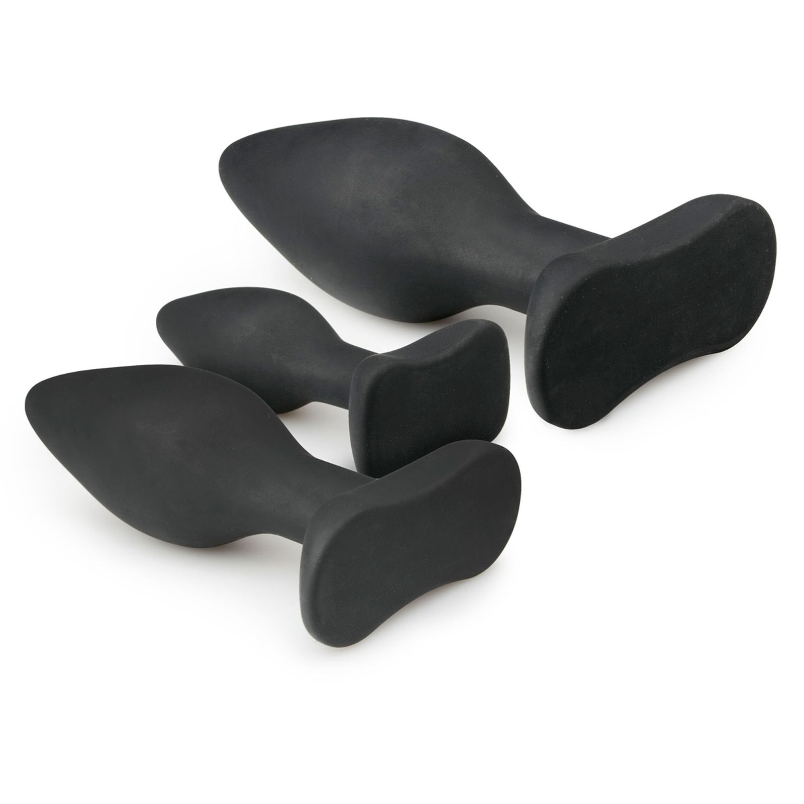 Drei schwarze Analplugs aus Silikon. Unterschiedliche Größen, konische Form mit breiter Basis.