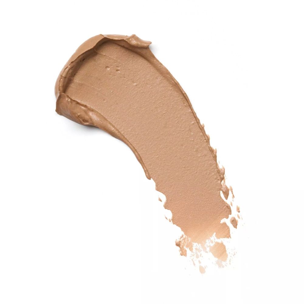 Heller, cremefarbener Make-up-Abstrich auf weißem Hintergrund. Textur sichtbar.