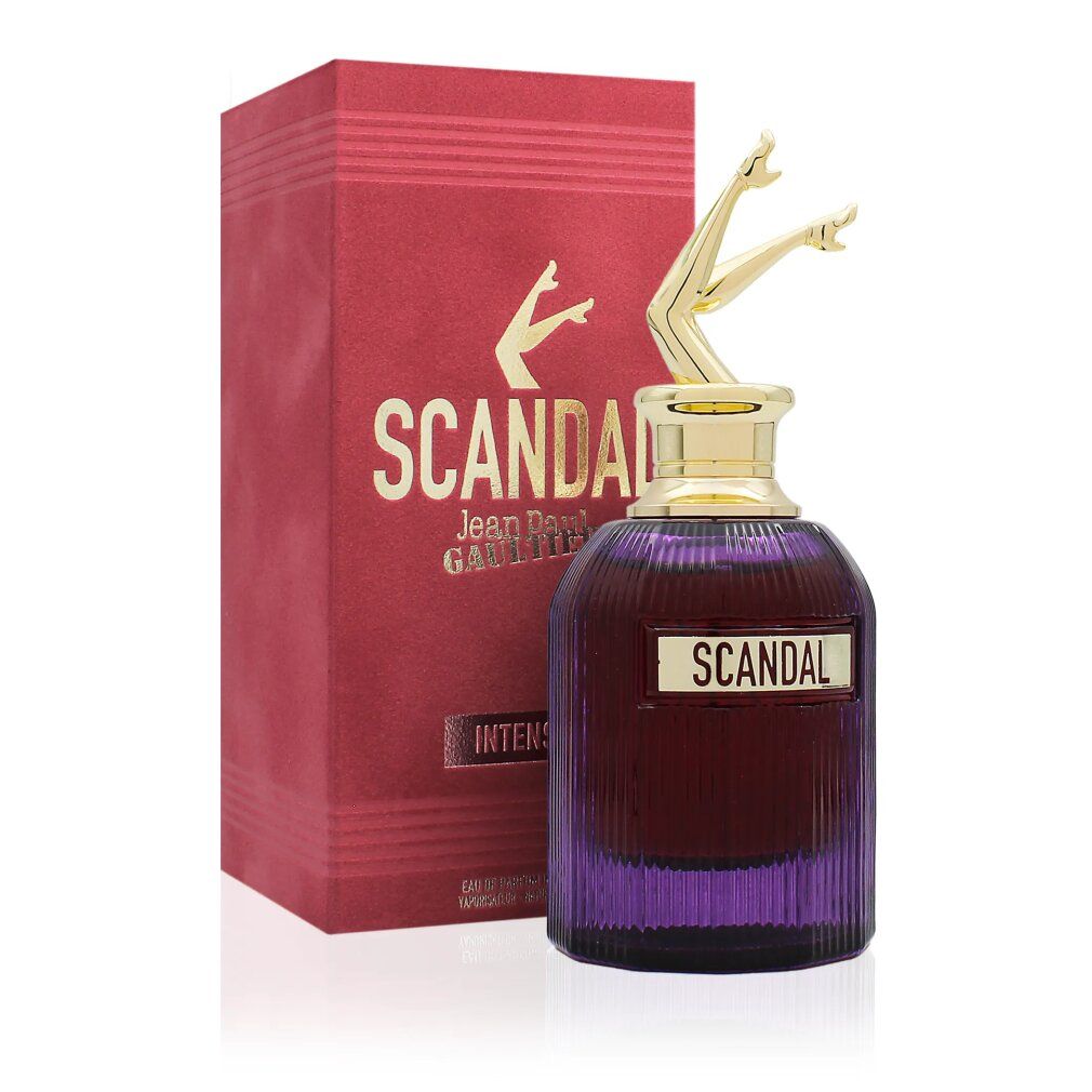 Rot-goldene Verpackung mit Flakon. Flakon mit goldfarbenen Beinen als Verschluss. Aufschrift "SCANDAL" und Markenname.