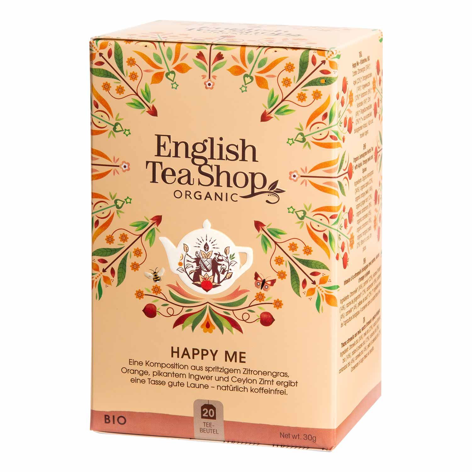 Karton von ETS - Happy Me Wellness-Tee bio. Aufdruck: English Tea Shop Organic, Happy Me, 20 Teebeutel, Bio-Siegel. Beige mit floralem Muster.