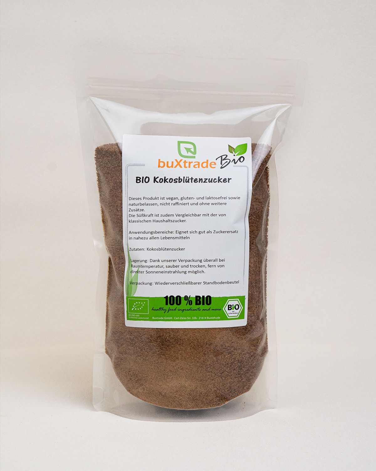 Transparente Verpackung mit braunem Zucker. Aufdruck: buXtrade Bio Kokosblütenzucker, 100% BIO.