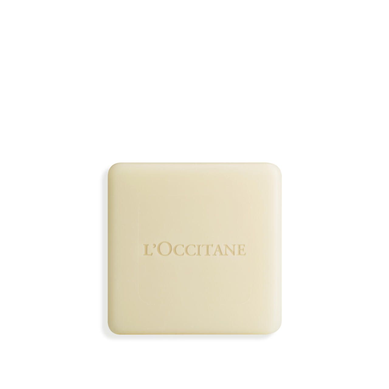 Quadratische Seife mit geprägtem L'Occitane-Logo. Helle, cremefarbene Seife mit abgerundeten Kanten.