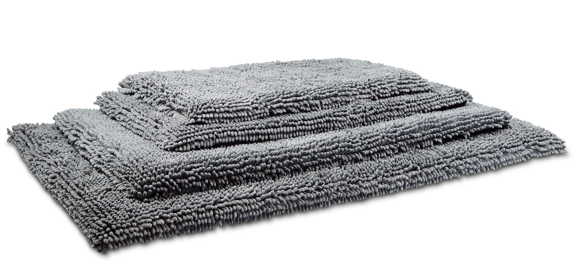 Graues Reise Pad, rechteckig, aus flauschigem Material. Mehrere Pads gestapelt, unterschiedliche Größen. Wolters.