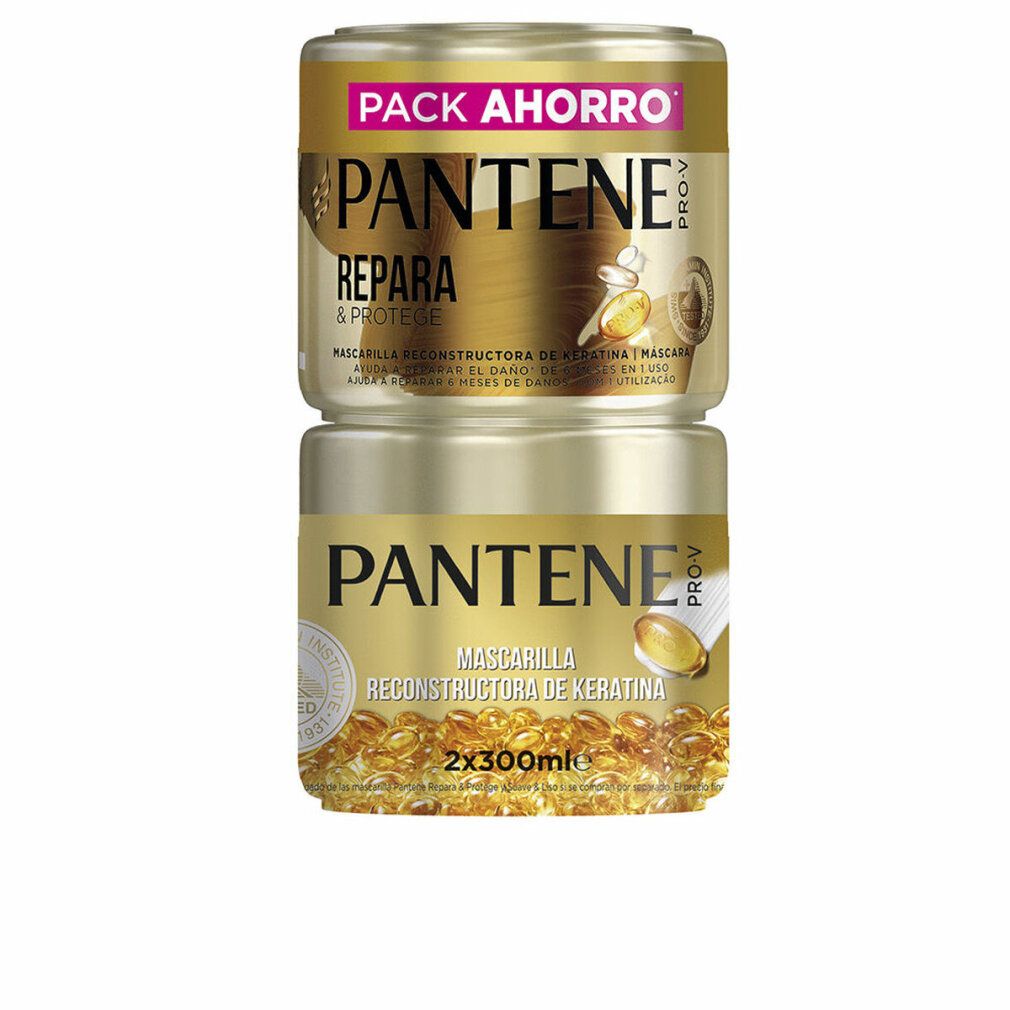 Zwei goldfarbene Tiegel, übereinander gestapelt. Aufschrift: PANTENE PRO-V, REPARIERT & SCHÜTZT, MASKE. Unterer Tiegel: MASCHERA RECONSTRUCTORA DE KERATINA.