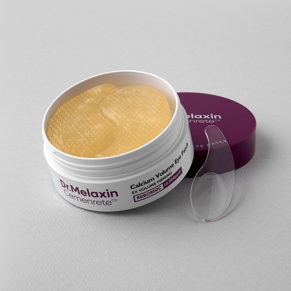 Dr. Melaxin Cemenrete Calcium Volume Eye Patch Behälter mit gelben Augenpads und Spatel.