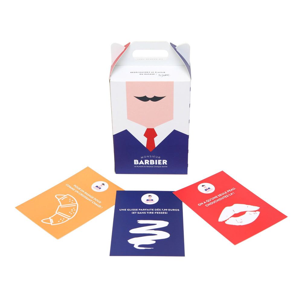 Geschenkbox mit Bart-Design und drei Karten. Box mit Griff. Karten: Croissant, Wellen, Lippen. Alle mit Logo.