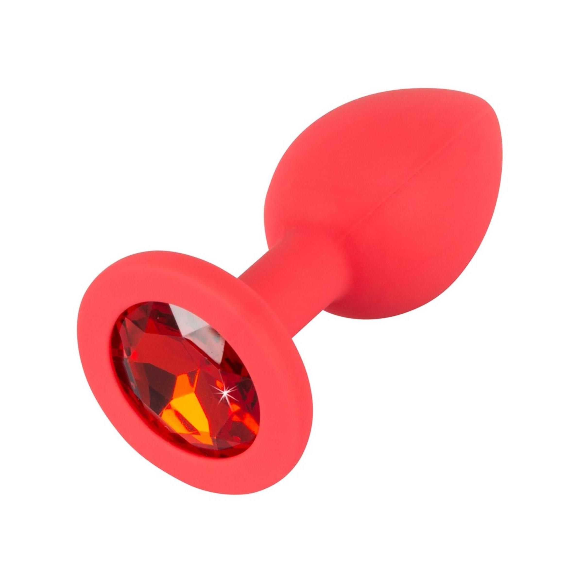 Roter Plug mit rotem Schmuckstein. Kegelförmiger Aufsatz, runder Sockel. Detailansicht.