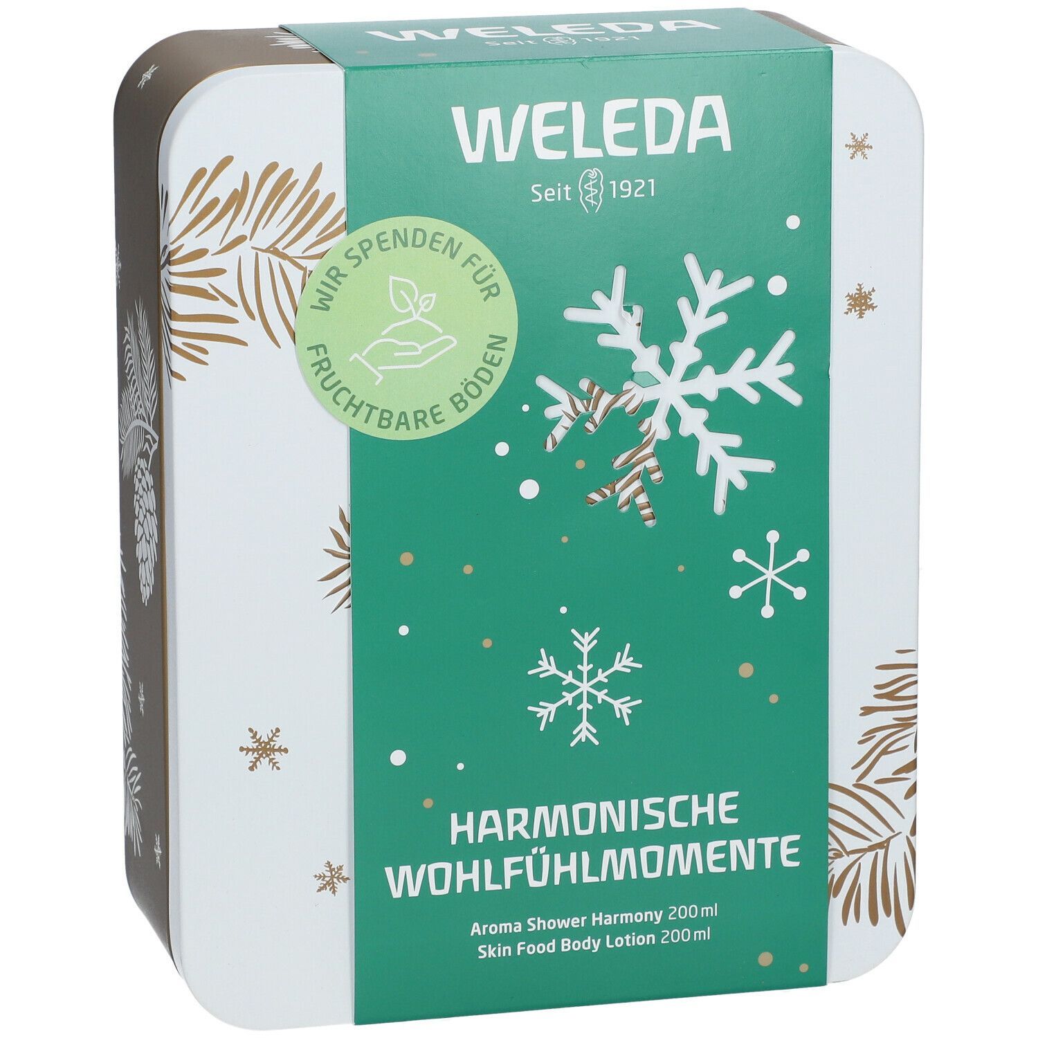 Geschenkset-Box mit grünem Deckel. Aufschrift: Weleda, Harmonische Wohlfühlmomente. Schneeflocken-Design. Seit 1921.