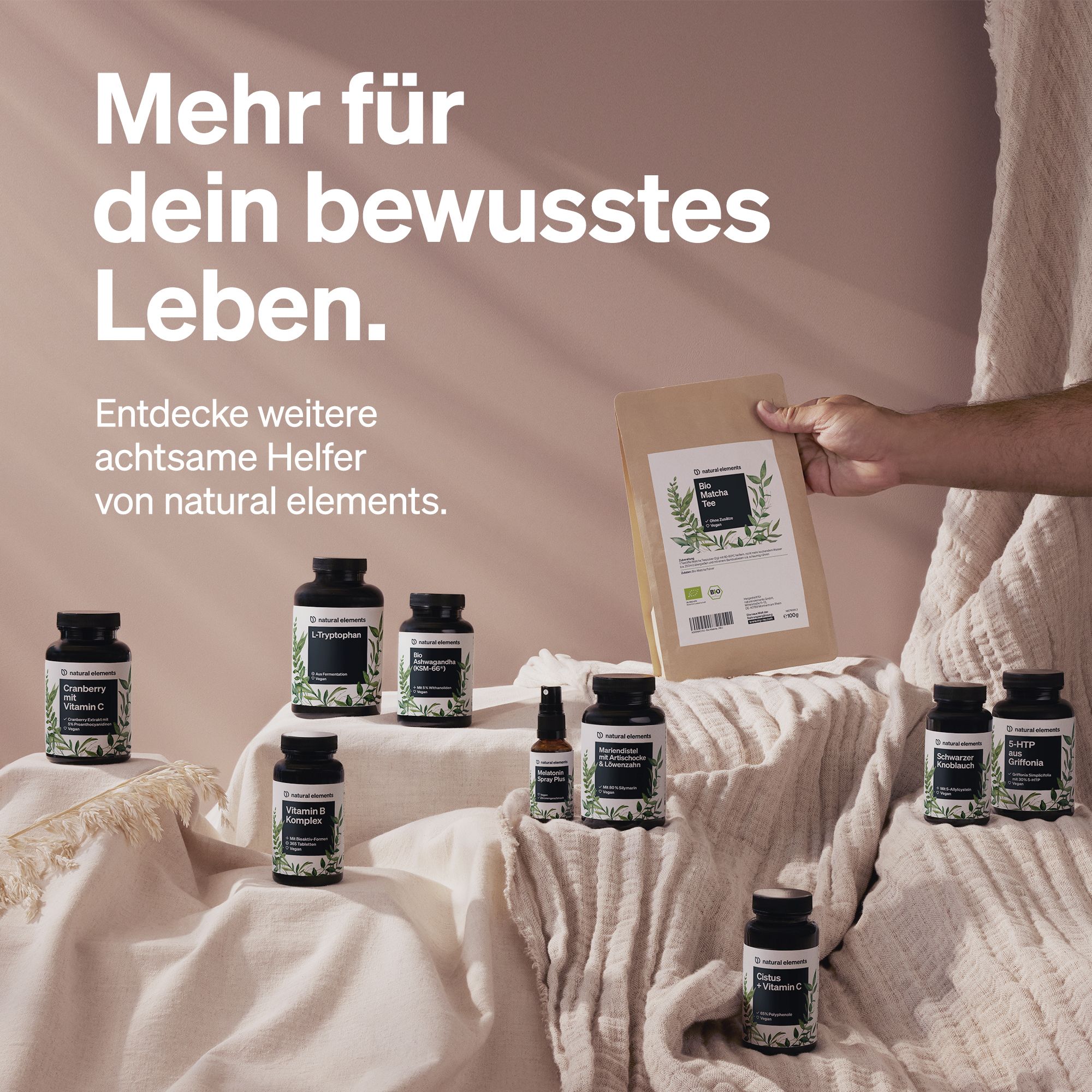 Verschiedene Flaschen und eine Tüte. Text: Mehr für dein bewusstes Leben. Marke: natural elements. Produkte auf einer Oberfläche präsentiert.