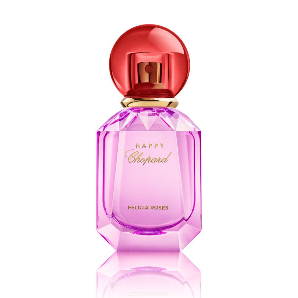 Rosa Parfümflasche mit rotem Deckel. Aufschrift HAPPY Chopard FELICIA ROSES. Flakon mit Facetten.