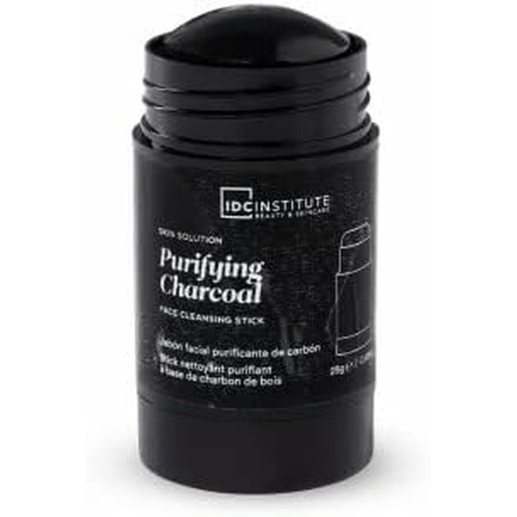 Schwarzer Reinigungsstick. Aufschrift: Purifying Charcoal, IDC INSTITUTE. Zylinderförmige Verpackung.