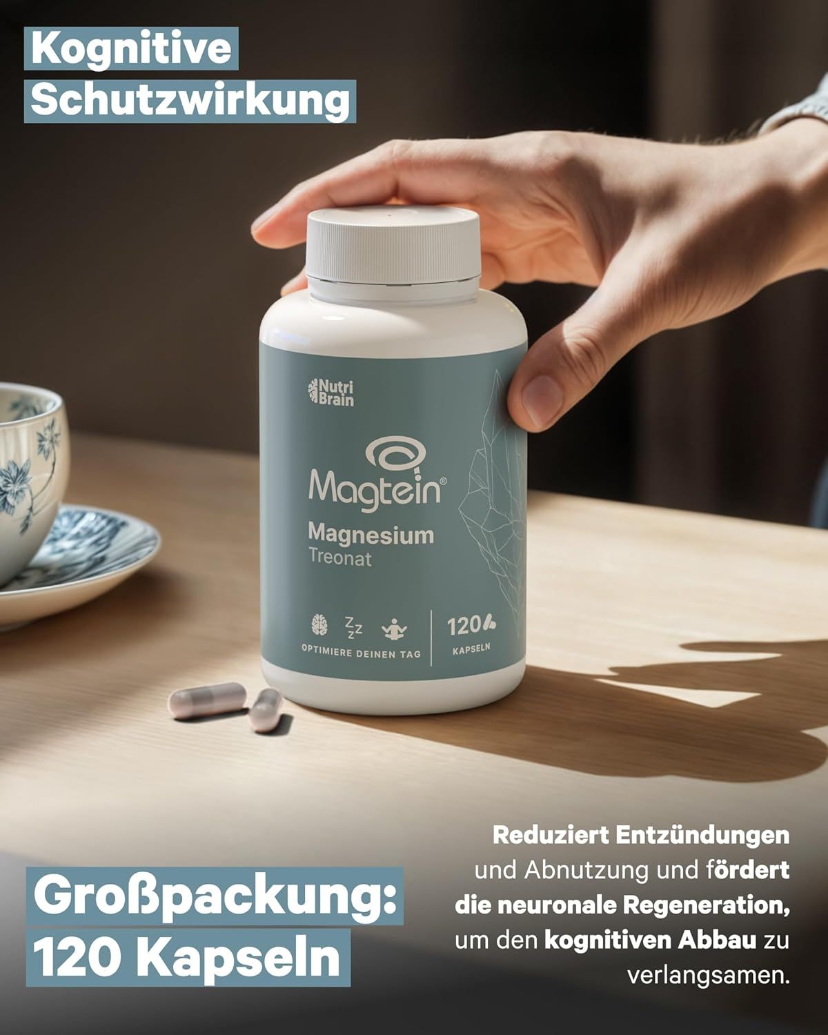Hand hält eine Dose Magtein Magnesium Treonat, 120 Kapseln, mit Text über kognitive Regeneration.