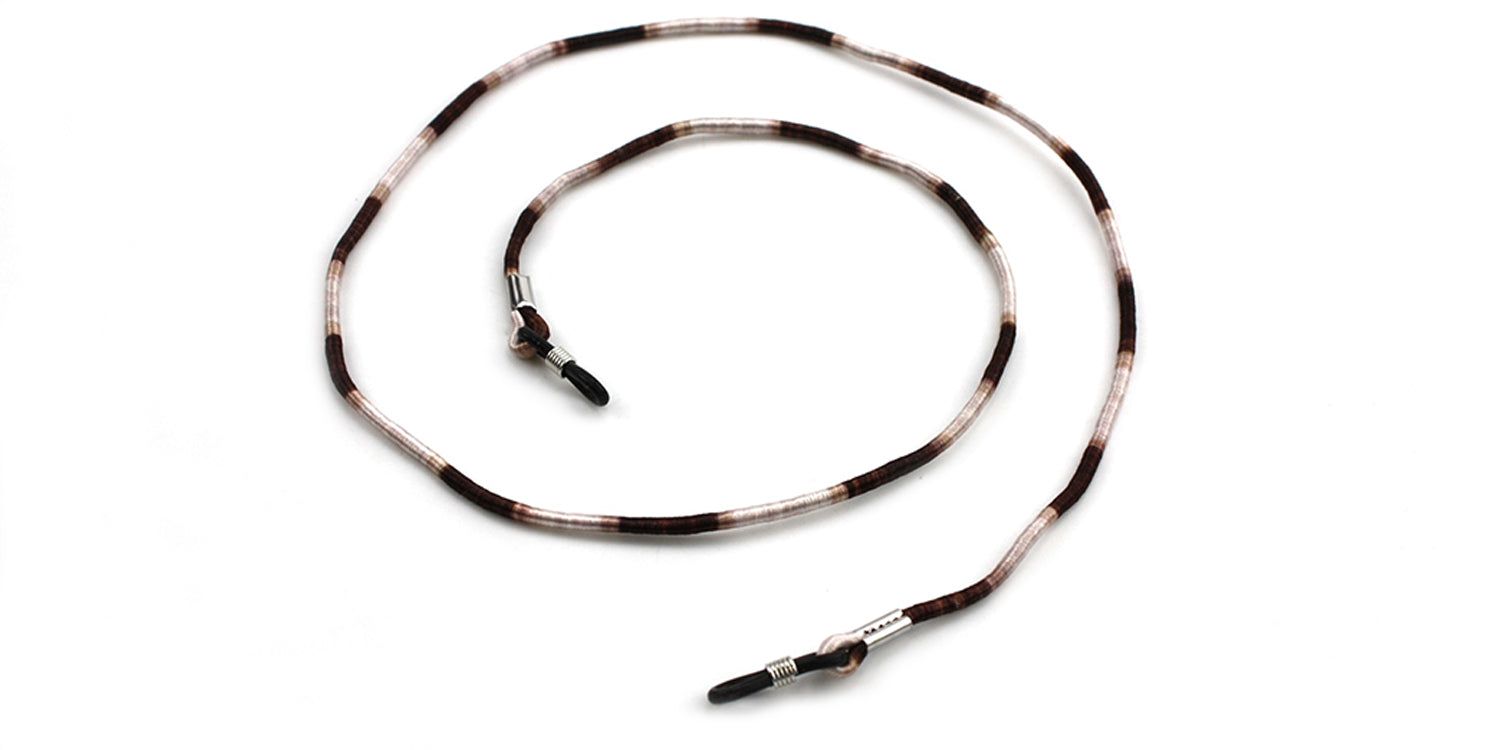 Brillenband, weiß-braun gestreift. Enden mit schwarzen Schlaufen. Metallringe zur Befestigung.