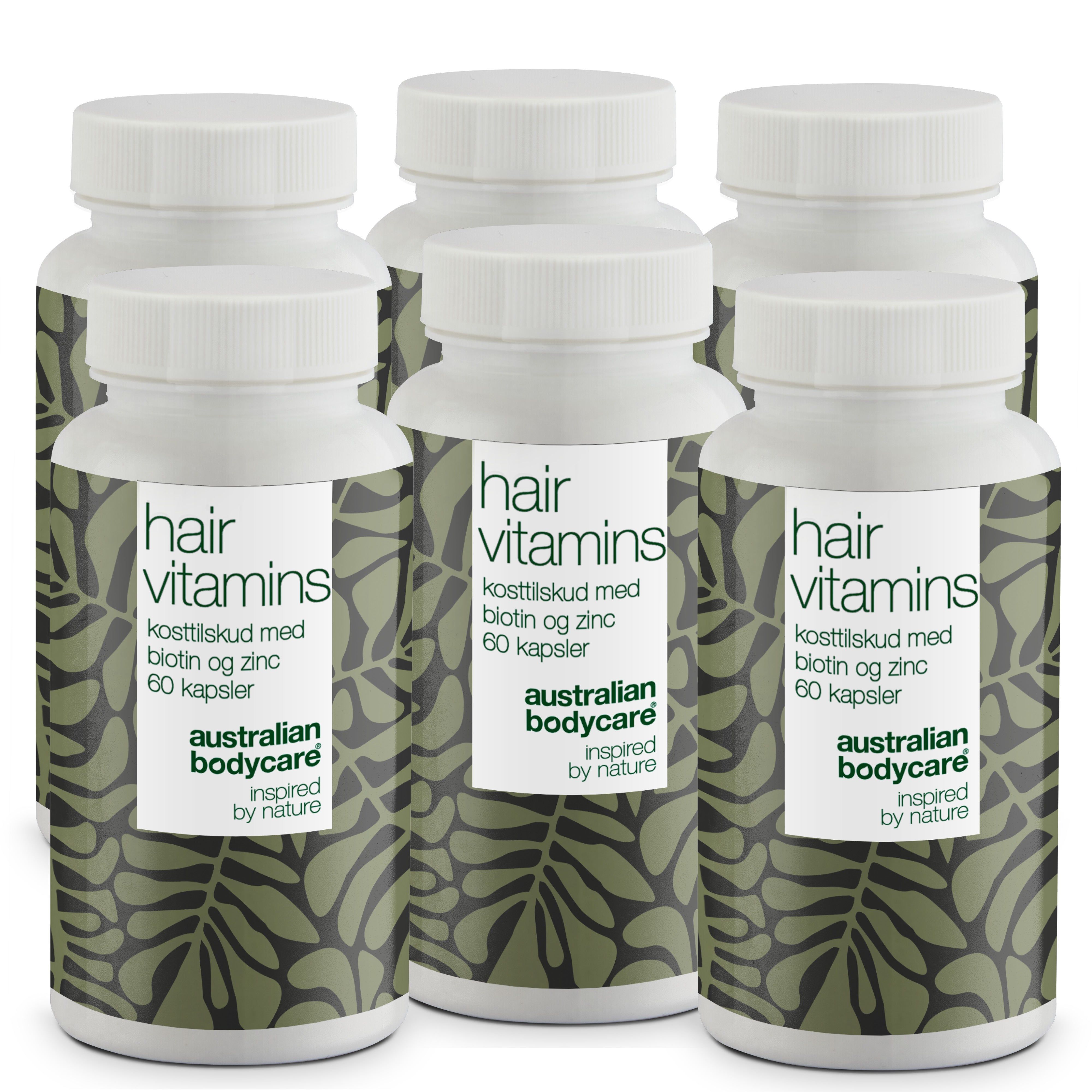 Mehrere weiße Flaschen mit Etiketten. Auf den Etiketten steht "hair vitamins" und "Australian Bodycare".