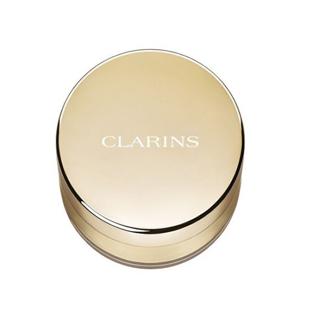 Geschlossene Puderdose. Goldfarbener Deckel mit Schriftzug CLARINS. Runde Form.