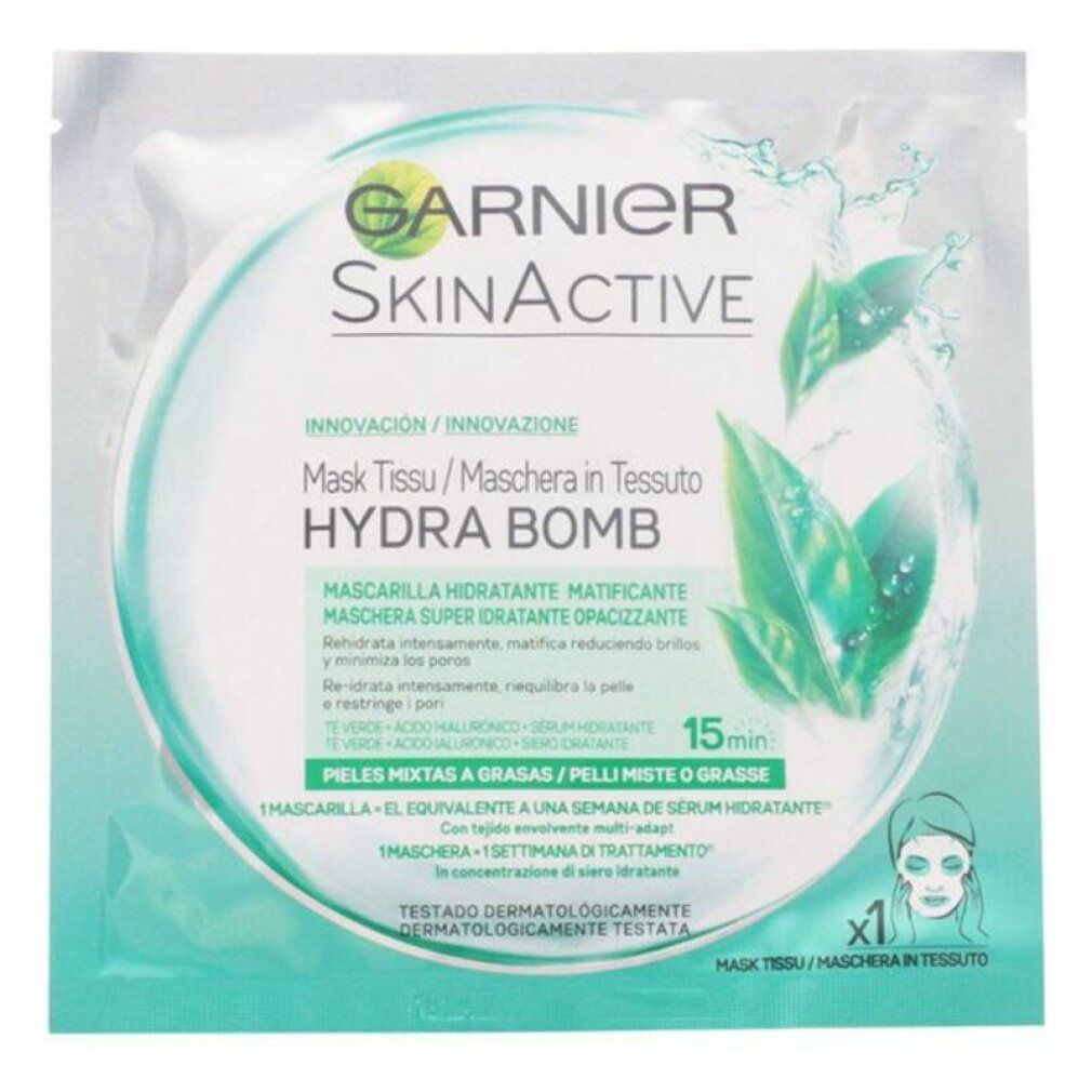 Garnier SkinActive Hydra Bomb Gesichtsmaske. Runde Verpackung mit Produktabbildung und Text. Grün-weißes Design mit Logo und Produktnamen.