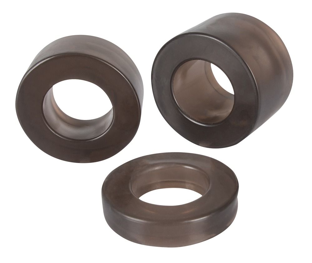 Drei dunkle Ringe mit zentraler Öffnung. Unterschiedliche Größen, aus dunklem Material.