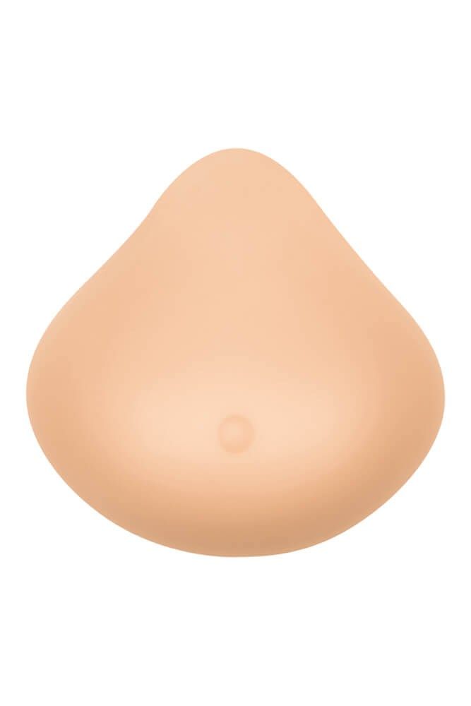 Elfenbeinfarbene Brustprothese. Tropfenförmig, mit einer kleinen Erhebung. Vollflächige Haftung.