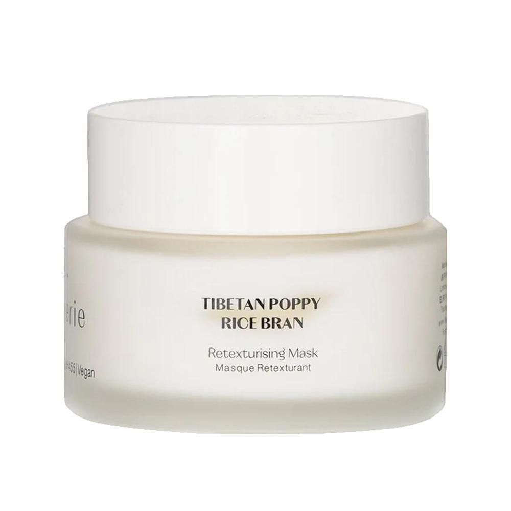 Weißes Tiegel mit Deckel. Aufschrift: Tibetan Poppy Rice Bran. Retexturierende Maske. Vegan. Flânerie Logo.