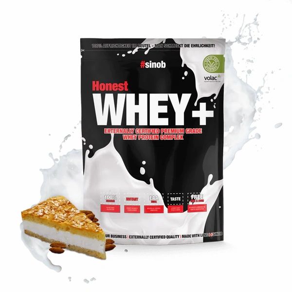 Schwarze Tüte mit "Honest WHEY+". Enthält Molkenprotein. Mit Milchspritzern und Kuchenstück. Volac-Zertifizierung.