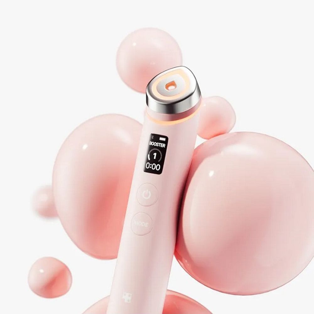 Rosa Beauty-Wand mit orangefarbenem Kopf. Rosa Kugeln im Hintergrund.