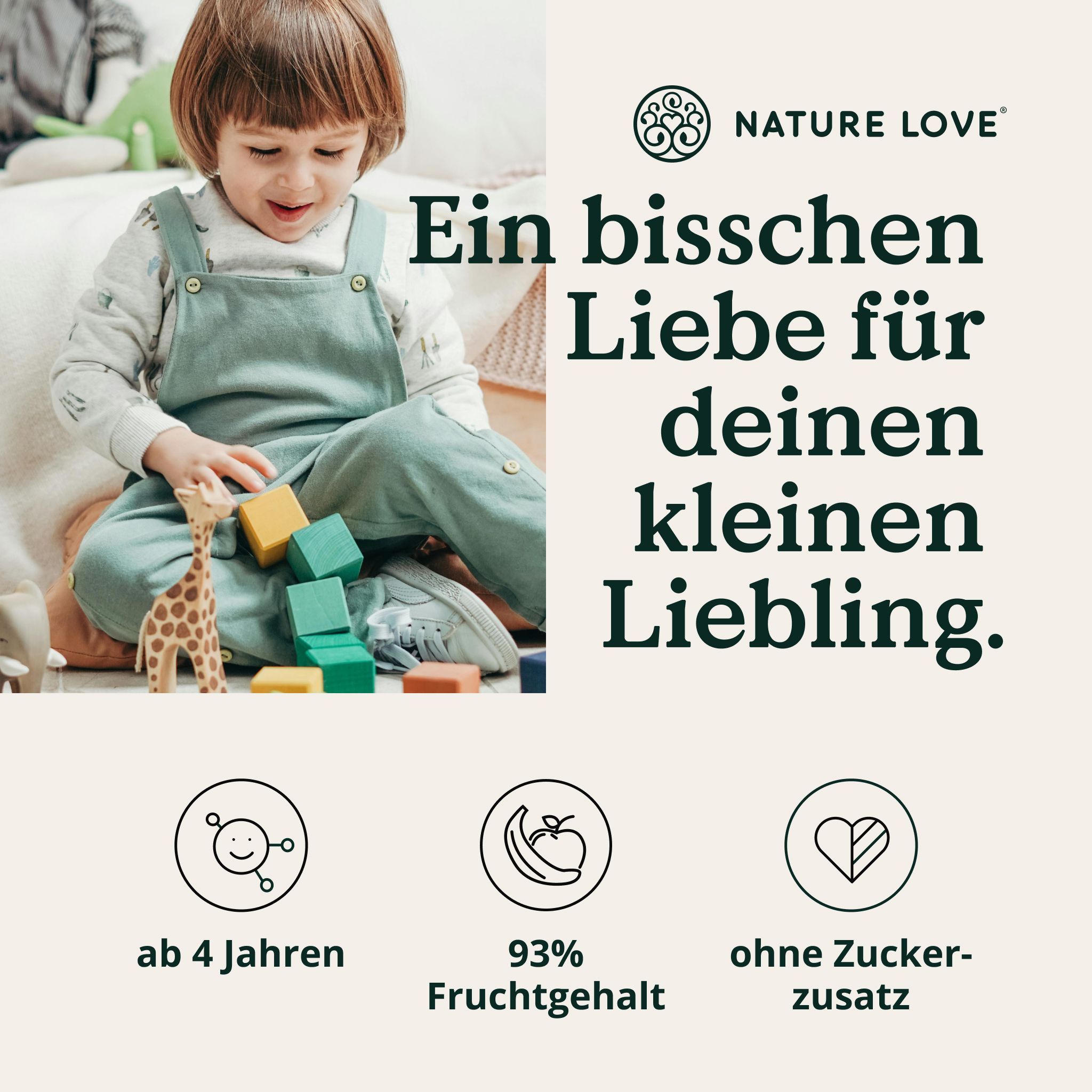 Ein kleines Kind spielt mit Bauklötzen und einer Giraffe. "Ein bisschen Liebe für deinen kleinen Liebling."