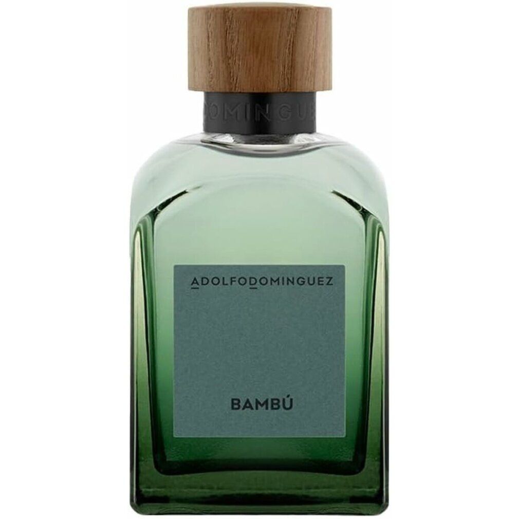 Grüne Glasflasche mit Holzdeckel. Auf dem Etikett steht "Bambú" und der Markenname "ADOLFO DOMINGUEZ".