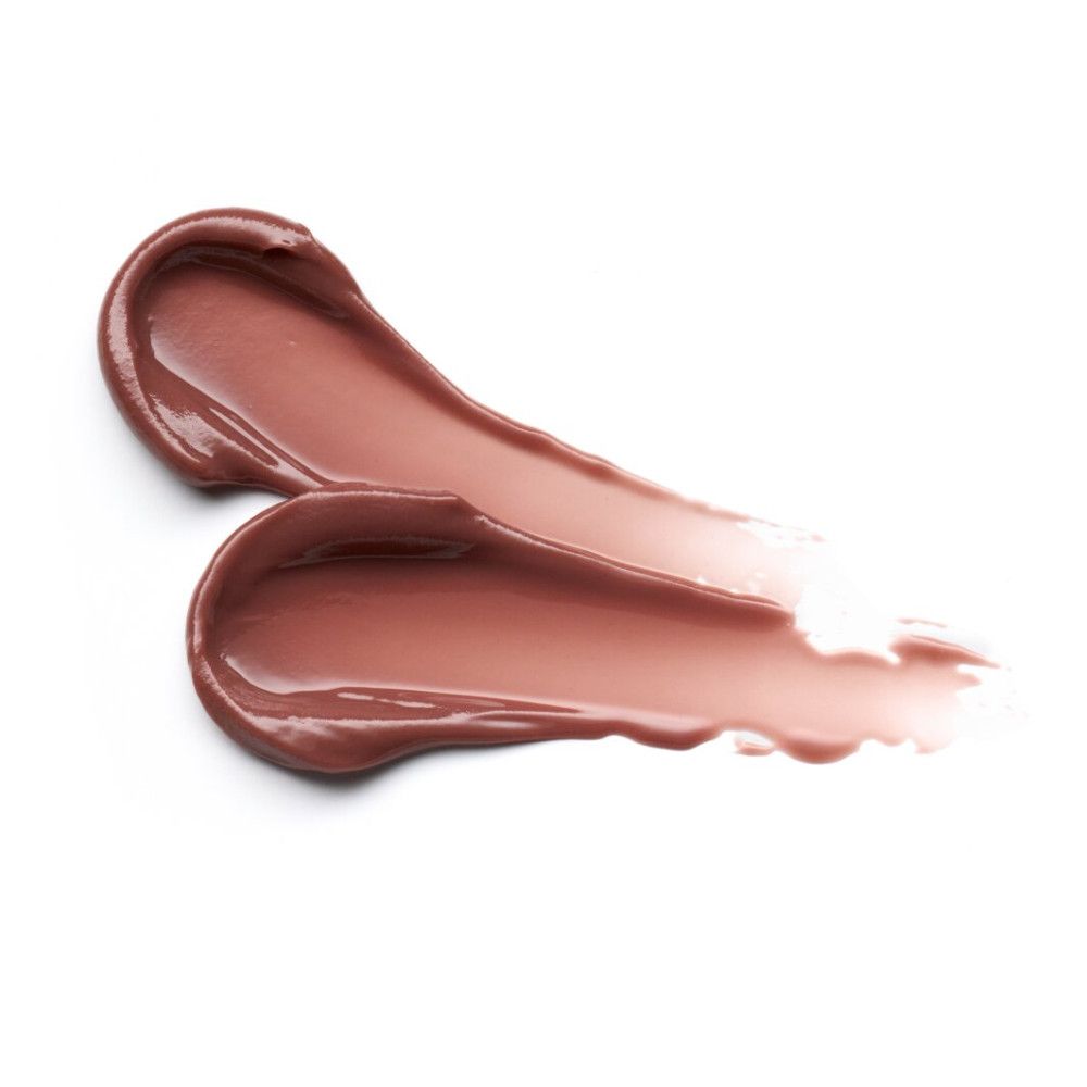 Zwei cremefarbene Lippenbalsam-Striche auf weißem Hintergrund. Glänzende Textur.