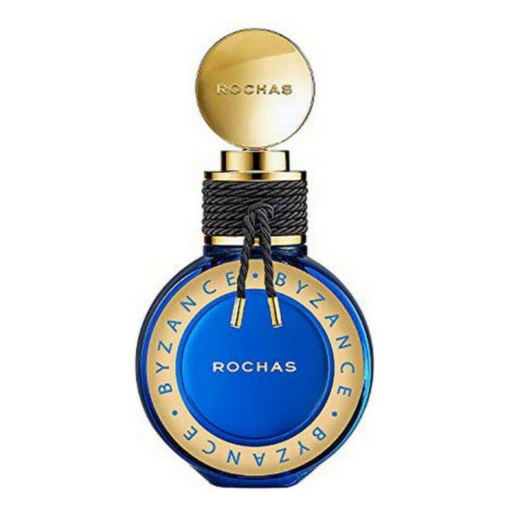 Blaue Parfumflasche mit goldenen Details. Aufschrift: BYZANCE, ROCHAS. Goldener Deckel, schwarzes Band um den Hals.