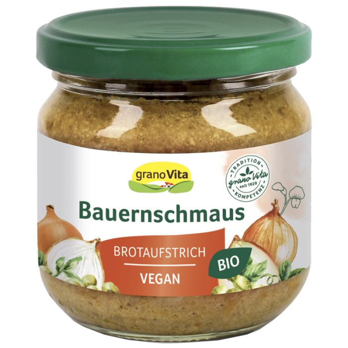 Glas mit Bauernschmaus-Brotaufstrich von Granovita. Grüner Deckel, weißes Etikett mit Produktnamen und Bio-Siegel. Abbildung von Zwiebeln.