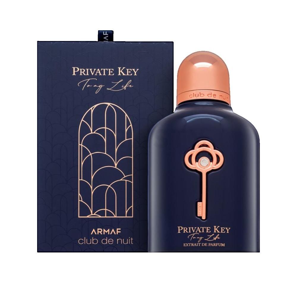 Dunkelblaue Parfumflasche mit kupferfarbenem Verschluss und Schlüssel-Design. Rechteckige Schachtel mit Logo.